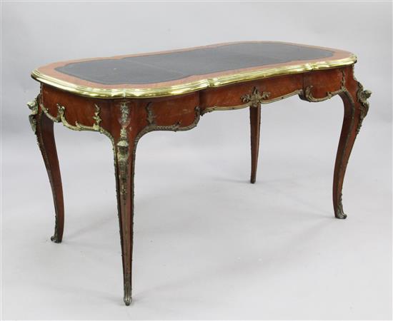 A French Louis XV style serpentine shape kingwood and ormolu mounted bureau plat, W.4ft 7in.